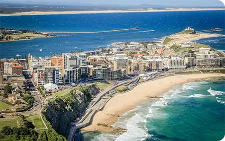 Newcastle coastal city landscape showing surf, city skyline and creative spirit